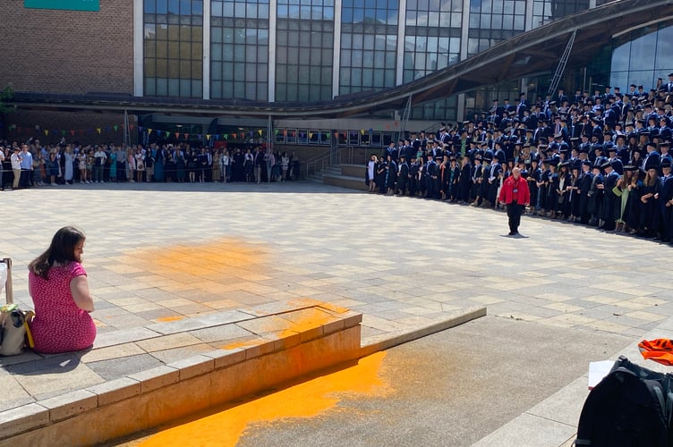 Outside the Great Hall, orange paint which had been sprayed by the protester.