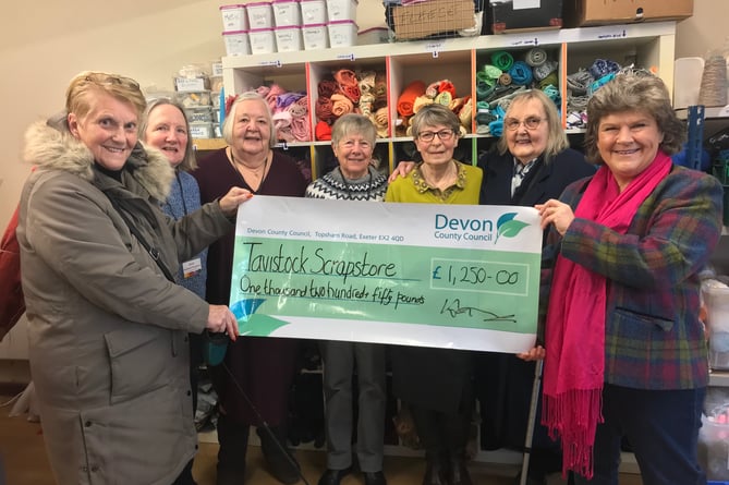 Cllr Debo Sellis, right, presents the county council cheque to chair of the Scrapstore Penny Blackmore, far left