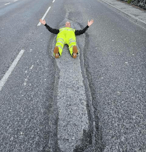 The largest pothole in Tavistock - on Plymouth Road - swallows up campaigner David Newcombe. 