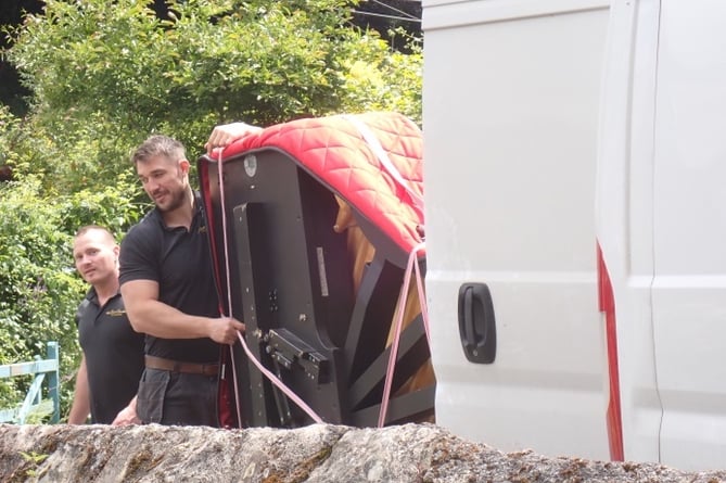 The piano being loaded into a van to be transported back to London after the festival.