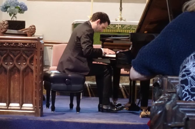 Emanuel Despax performing in the church at Milton Combe