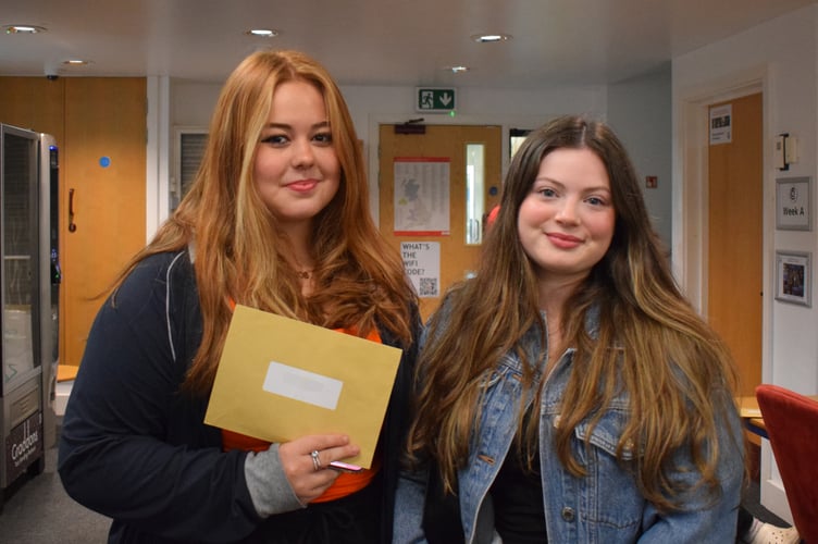 Students Jessica Carter and Jasmine King with their results